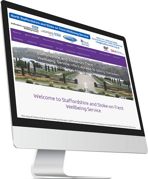 desktop computer with NHS website on screen